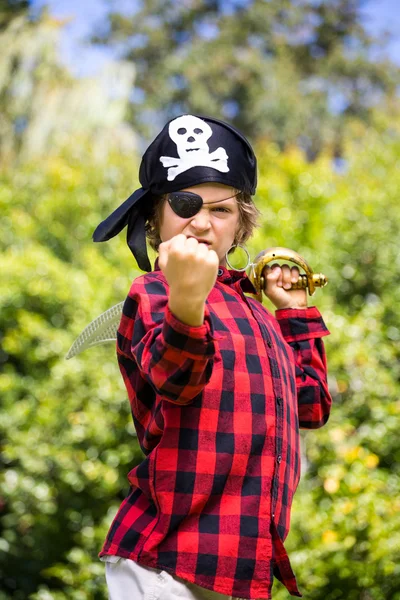 A kid with a costume of pirate is showing his strength — Stock Photo, Image