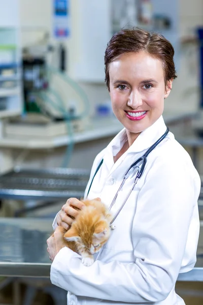 Портрет женщины-ветеринара, улыбающейся и держащей котенка — стоковое фото