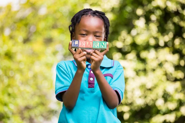 Boy holding the word learn — Stock Photo, Image