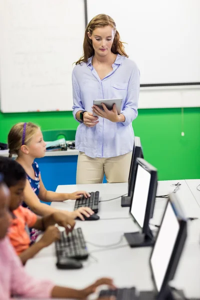 Lehrerin erteilt ihren Schülern Unterricht mit Technik — Stockfoto