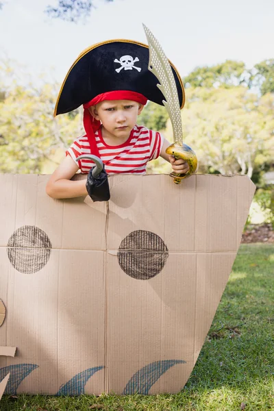 Portrait of a child with fancy dress inside a cardboard boat — Stock Photo, Image