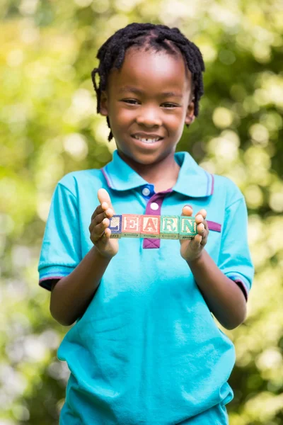 Boy holding the word learn — Stock Photo, Image