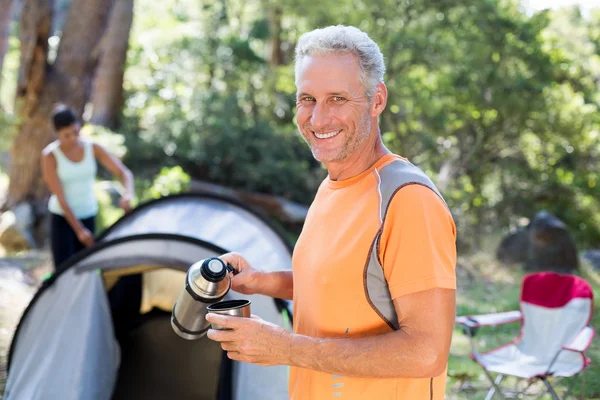 Man smiling and taking some drink — Stock Photo, Image
