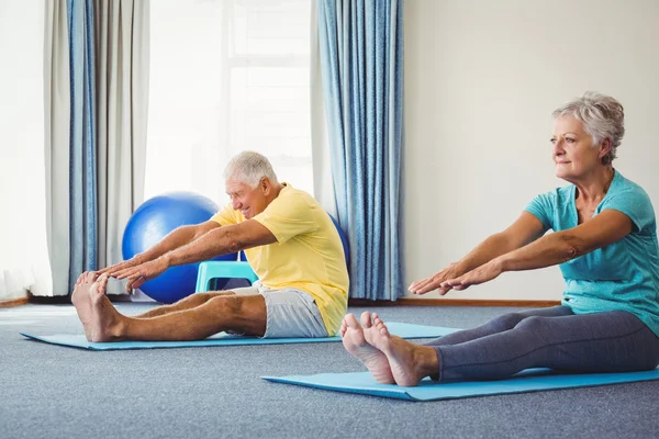 Side view of seniors doing exercises