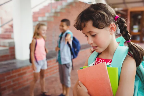 Brunette girl mocked by two children behind her — Stock Photo, Image