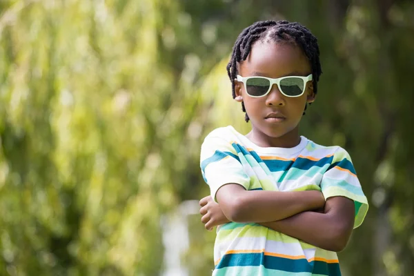 A kid with sunglasses crossing his arms — Stock Photo, Image