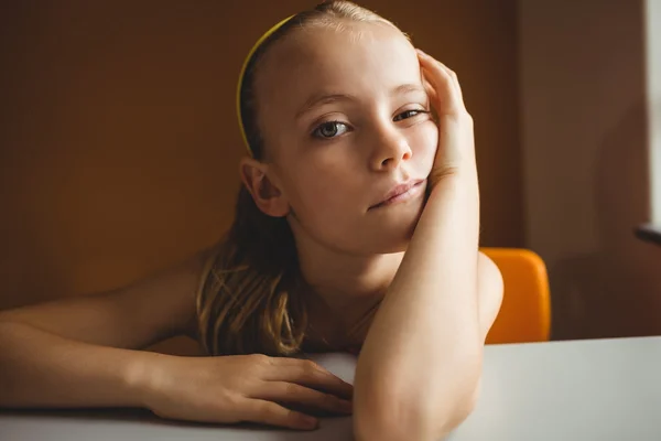 Bored schoolchild sitting on chair — Stock Photo, Image