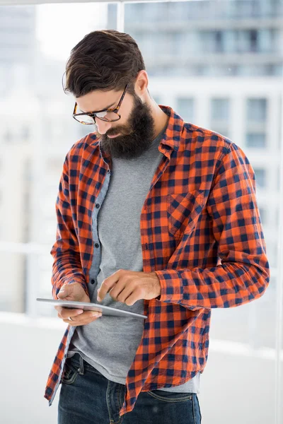 Hipster is using tablet and standing — Stock Photo, Image