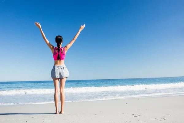 Mujer con las manos arriba en la playa — Foto de Stock