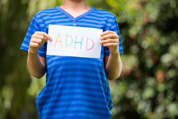 Portrait of young boy holding a message — Stock Photo, Image