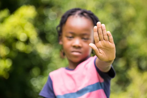 Serious boy showing stop sign with his hand — Zdjęcie stockowe