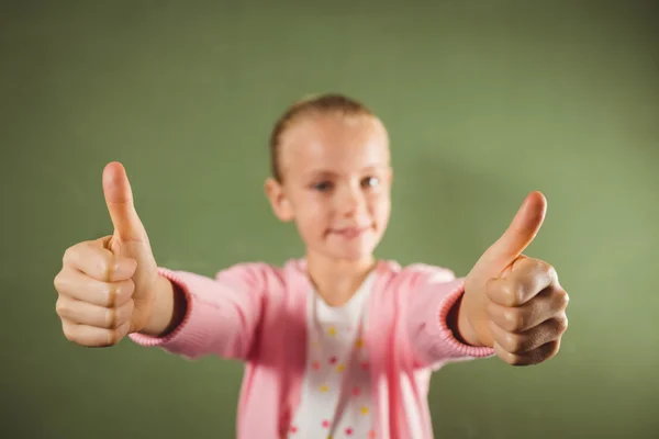 Girl standing with thumbs up — Stock Photo, Image