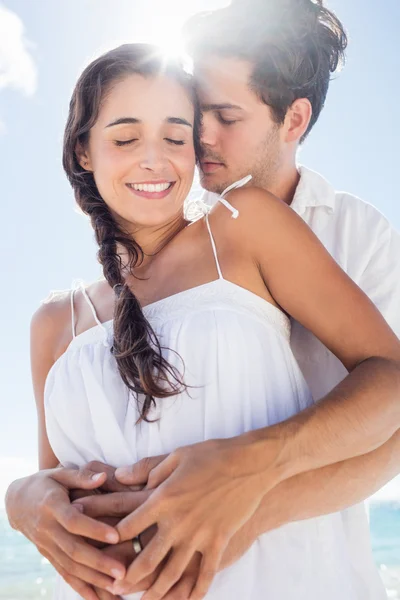 Happy couple embracing on the beach Stock Photo