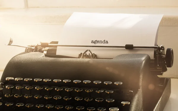Agenda contra máquina de escrever em uma mesa — Fotografia de Stock