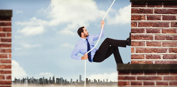 Businessman pulling a rope with effort — Stock Photo, Image