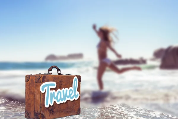 Beautiful smiling woman in white bikini skipping on the beach — Stock Photo, Image