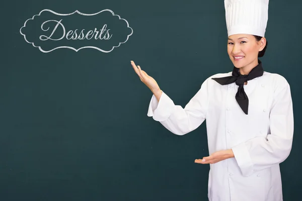 Portrait of a smiling female cook in kitchen — Stock Photo, Image