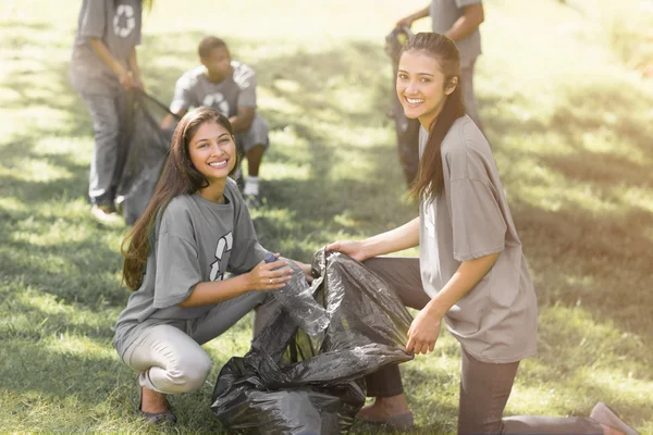 Team of volunteers picking up litter in park — Stock Photo, Image