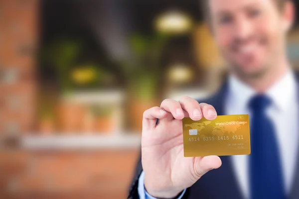 Happy businessman showing a creditcard — Stock Photo, Image