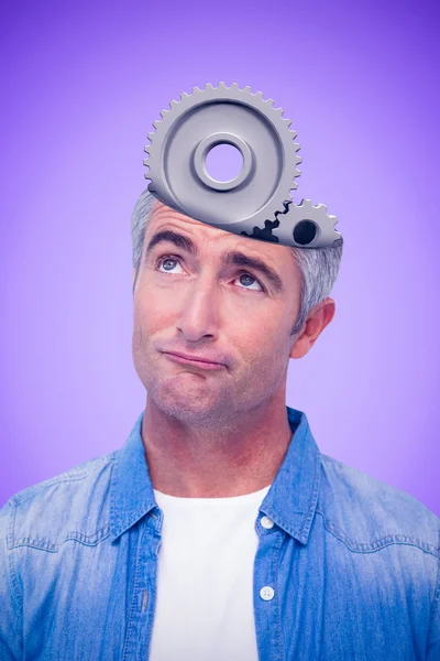 Composite image of confused man with grey hair thinking — Stock Photo, Image