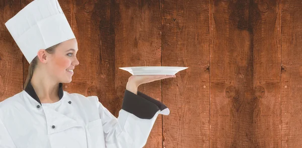 Woman chef holding a plate — Stock Photo, Image