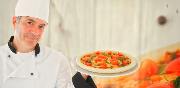 复合图像的友好厨师拿着披萨 — 图库照片