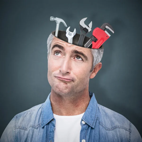 Workman with tools in head — Stock Photo, Image