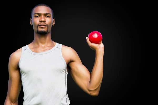 Serious sportsman is holding shot put — Stock Photo, Image