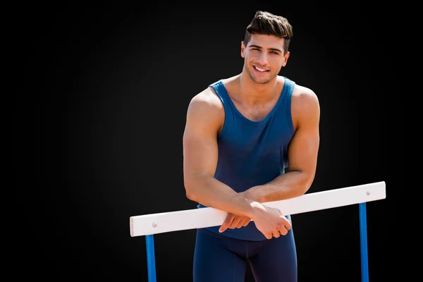 Sportsman is smiling and posing on hurdle — Stock Photo, Image