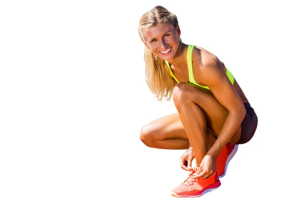 Sporty woman doing shoelace — Stock Photo, Image
