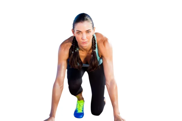 Sporty woman in starting block — Stock Photo, Image