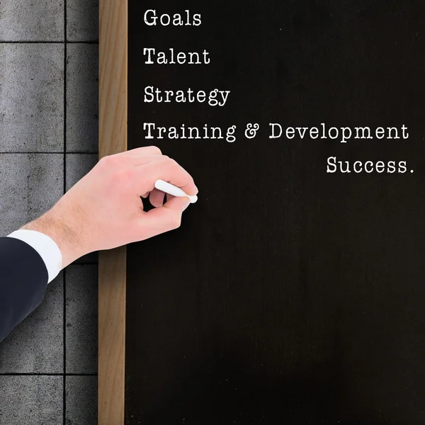 Hand of businessman writing with white chalk — Stock Photo, Image