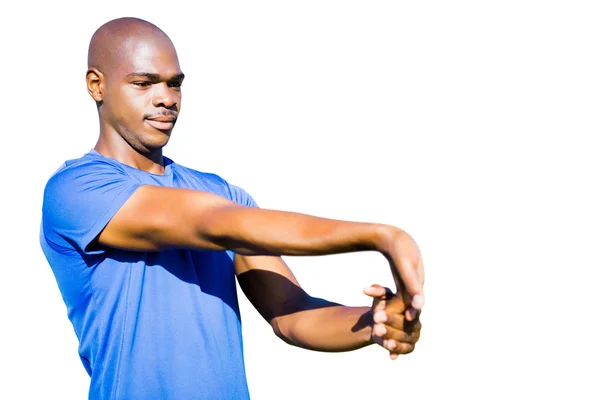 Desportista está esticando seus músculos — Fotografia de Stock
