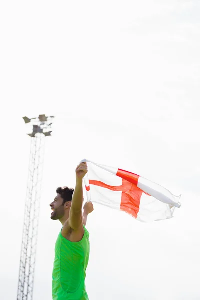 Sportovec pózuje s vlajkou, Anglie — Stock fotografie