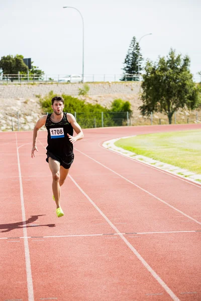 Athlete running on racing track — Stock Photo, Image