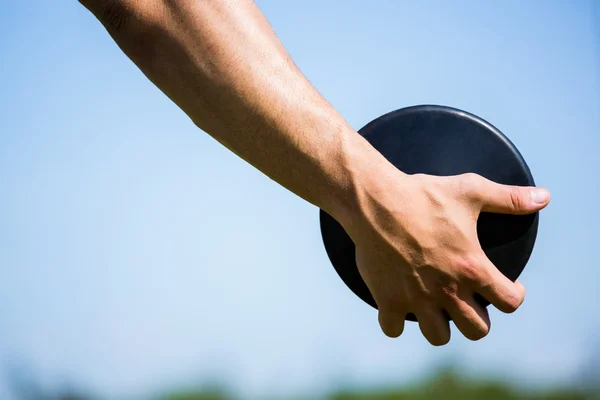 Hand holding a discus — Stock Photo, Image