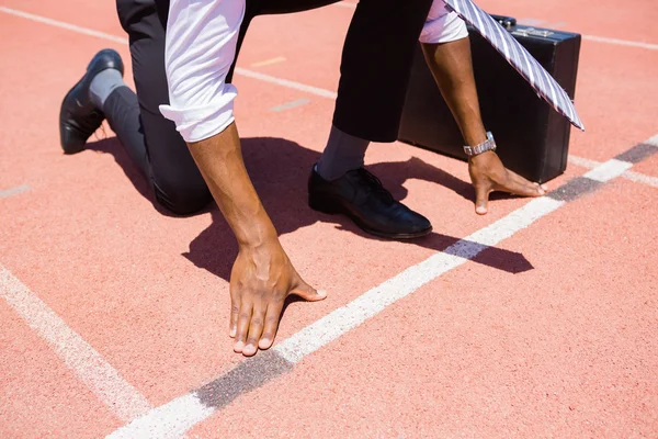 Businessman with briefcase ready to run — Stock Photo, Image