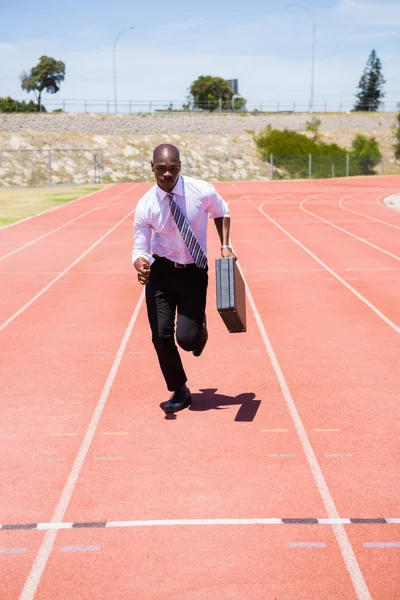 Empresário correndo na pista de corrida — Fotografia de Stock