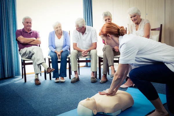 Nurse teaching first aid to seniors — Stock Photo, Image