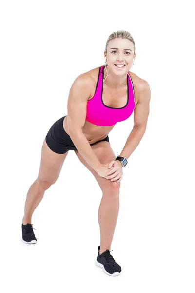 Female athlete stretching and listening music — Stock Photo, Image