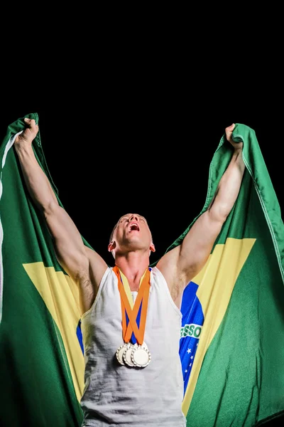 Athlete posing with gold medals — Stock Photo, Image