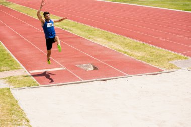 Athlete performing a long jump clipart