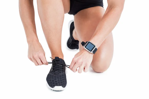 Female athlete tying her shoelace — Stock Photo, Image