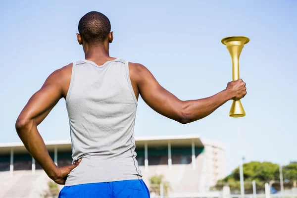 Athlete holding a fire torch — Stock Photo, Image