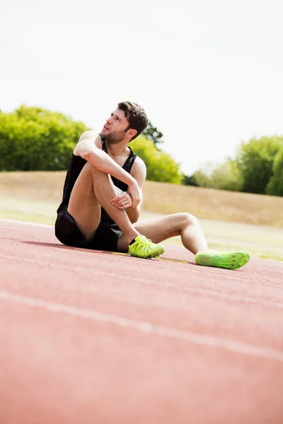 Tired athlete on running track — Stock Photo, Image