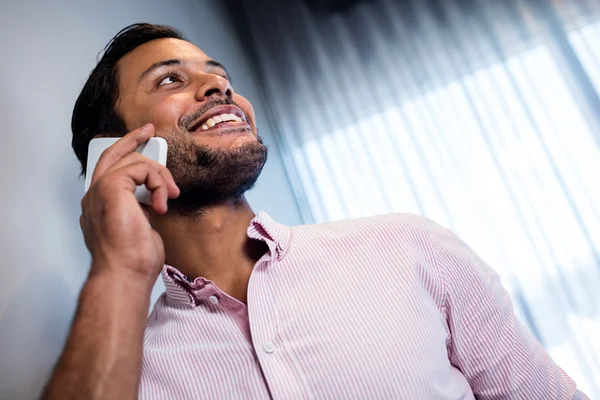 Homem de negócios sorrindo chamando com smartphone — Fotografia de Stock