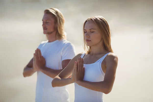 Uomo e donna che eseguono yoga — Foto Stock