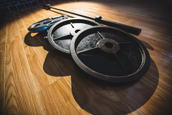 Barbell on wooden floor — Stock Photo, Image