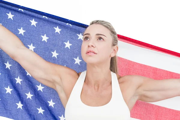 Female athlete holding American flag — Stock Photo, Image
