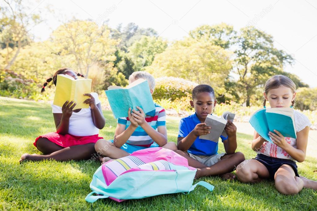 Kids reading books during sunny day Stock Photo by ©Wavebreakmedia